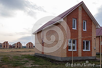 Construction of new model houses of red and yellow bricks. Copy space in the sky. Image for articles on new affordable housing Stock Photo