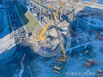 Construction of a new overpass in the city center. near the river, walking path and many buildings. the bridge is broken right on Editorial Stock Photo