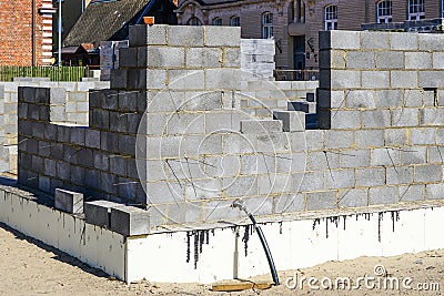 Construction of a new residential house from building blocks, insulation of foundations Stock Photo