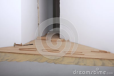 Construction in a new room installation of parquet Stock Photo