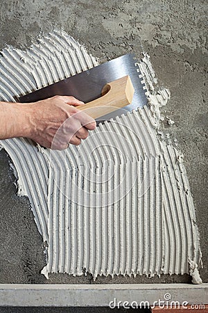 Construction notched trowel with white cement Stock Photo