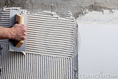 Construction notched trowel with white cement Stock Photo