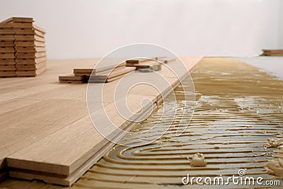 Construction in a renovated room installation of parquet Stock Photo