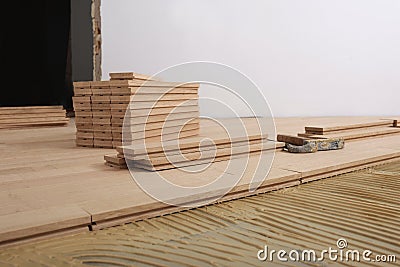 Construction in a renovated room installation of parquet Stock Photo