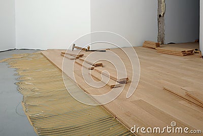 Construction in a renovated room installation of parquet Stock Photo