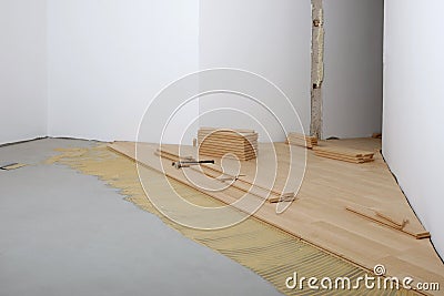 Construction in a renovated room installation of parquet Stock Photo