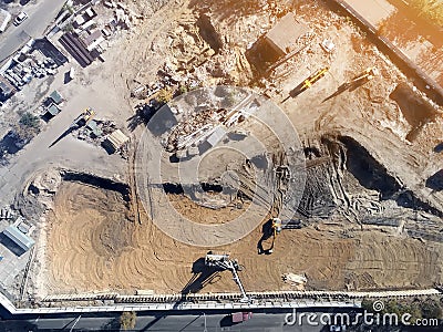 Construction site aerial view. Mall building base with solid concrete pillars. Heavy machinery piling and high tower crane working Stock Photo