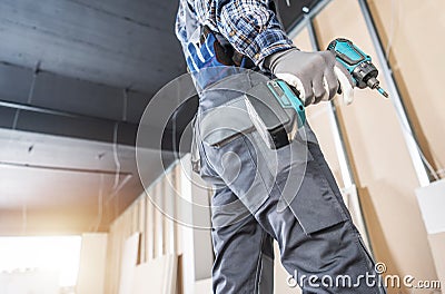 Construction Site Contractor Worker with a Drill Driver Stock Photo