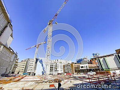 Construction site with cranes building new house Editorial Stock Photo