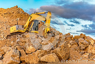 Construction site with an excavator moving rock Stock Photo