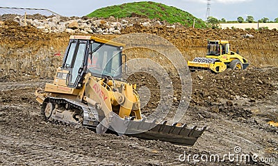 Construction Site with heavy excavating machinery Editorial Stock Photo