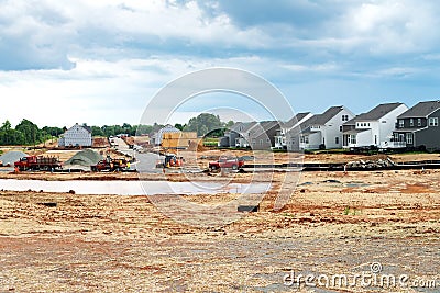 construction site of a large individual cluster of one-story houses. Marking foundations and laying asphalt roads Editorial Stock Photo