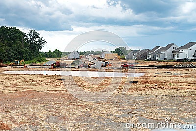 construction site of a large individual cluster of one-story houses. Marking foundations and laying asphalt roads Editorial Stock Photo