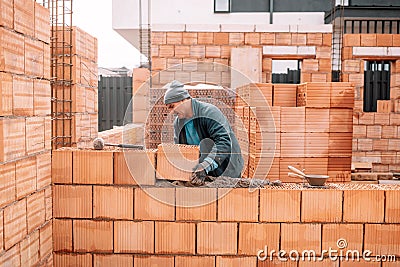 Construction site and mason bricklayer working with bricks Stock Photo