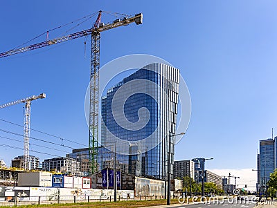 Construction site of Mennica Legacy Tower office complex of Mennica Polska and Golub Gethouse in rapidly developing Wola business Editorial Stock Photo