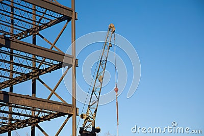 metal beams building frame structure iron steel construction site with crane Stock Photo