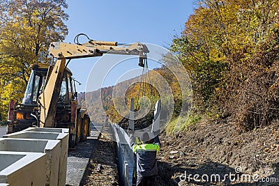 Construction site road burial of u-shaped gutter precast concrete drain Editorial Stock Photo