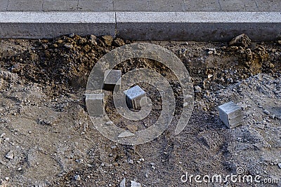 Construction site of a sidewalk with single paving stones Stock Photo