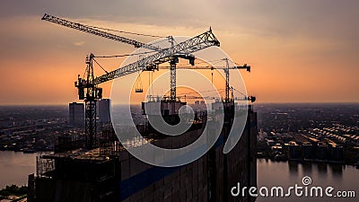 Construction site silhouette background, Hoisting cranes and new multi-storey buildings, Aerial view Industrial background Stock Photo