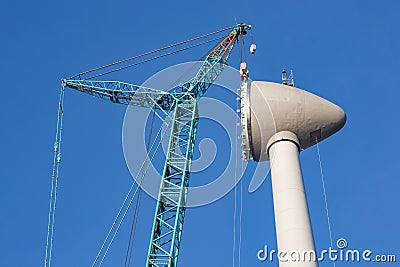 Construction site wind turbine with hoisting of rotor house Stock Photo