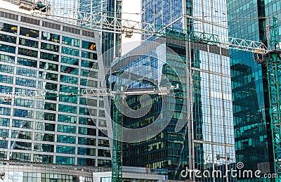 The construction of a skyscraper, a building of glass and concrete. Stock Photo