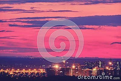 Construction stopped due to the coronavirus epidemic at sunset. Red sunset in the evening and construction of buildings in the Stock Photo
