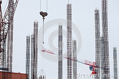 Construction, tall cranes, metal lattice and concrete reinforcement. Stock Photo