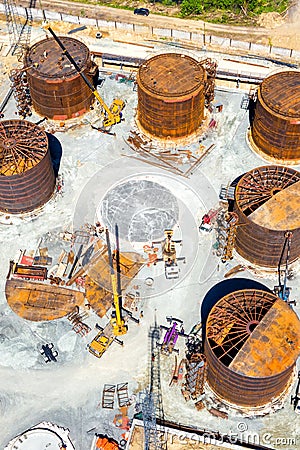 Construction of tank for an oil storage by sheet assembly. View from above. Flight around construction site Editorial Stock Photo