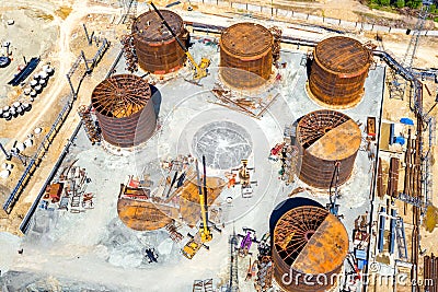 Construction of tank for an oil storage by sheet assembly. View above. Flight around construction site Editorial Stock Photo