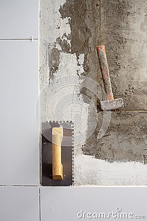 Construction tools notched trowel and hammer Stock Photo