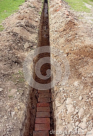 Construction of a trench for the passage of pipes in the earth Stock Photo