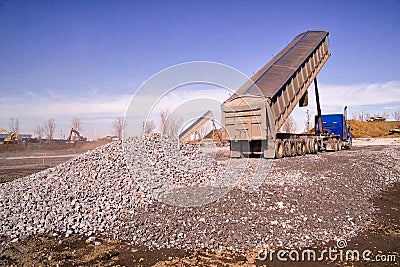 Construction truck tipping dumping gravel Editorial Stock Photo