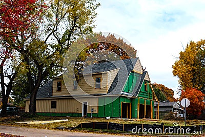 Construction of two story house in leafy neighborhood in Autumn Editorial Stock Photo