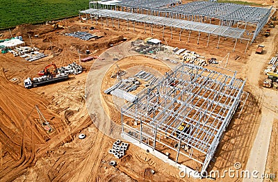 Construction of warehouse from metal structures. Industrial building on light gauge steel framing. Frame of modern hangar or Stock Photo
