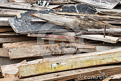 Construction waste after dismantling the formwork of a reinforced concrete foundation. Utilization of construction waste. Old Stock Photo