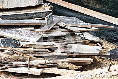 Construction waste after dismantling the formwork of a reinforced concrete foundation. Utilization of construction waste. Old Stock Photo