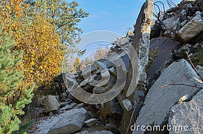 waste, reinforced concrete blocks and rusty fittings. Heap of damaged concrete blocks, piles and pipes Stock Photo