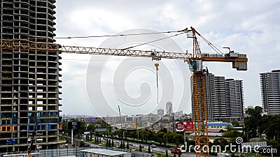 A construction work and a crane in a city Editorial Stock Photo