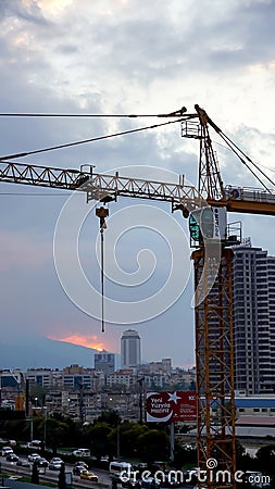 A construction work and a crane in a city Editorial Stock Photo