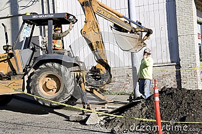 Construction worker bulldozer fixing street Editorial Stock Photo