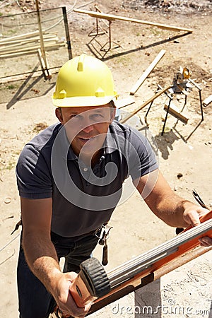 Construction Worker Climbing Ladder Stock Photo