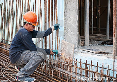 Construction worker cutting steel rods Stock Photo