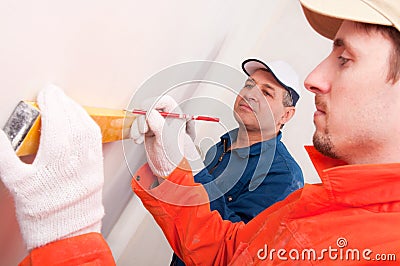 Construction worker doing measuring Stock Photo