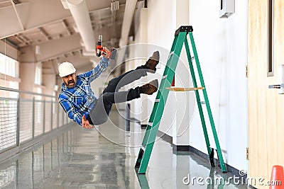 Construction worker falling off the ladder Stock Photo