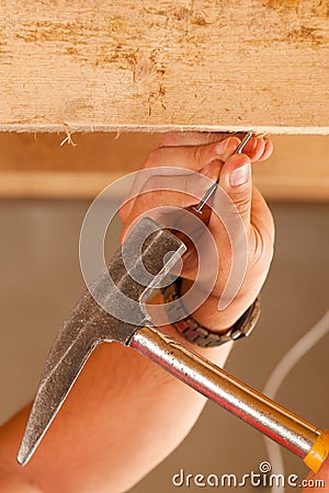 Construction worker with hammer and nail Stock Photo