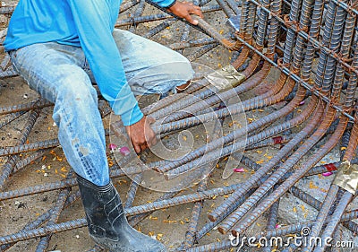 Construction worker hand working installing reinforcement mesh at building site Stock Photo