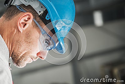 Construction Worker in Hard Hat and Eyes Safety Glasses Stock Photo