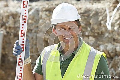 Construction Worker Holding Measure Stock Photo