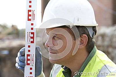 Construction Worker Holding Measure Stock Photo