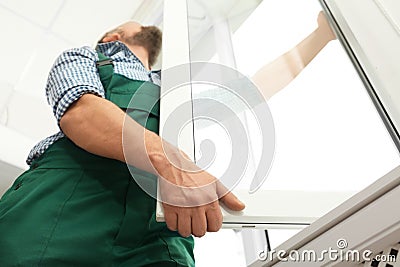 Construction worker installing new window Stock Photo